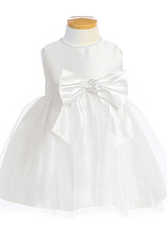 White dress with a large bow on a mannequin against a white background