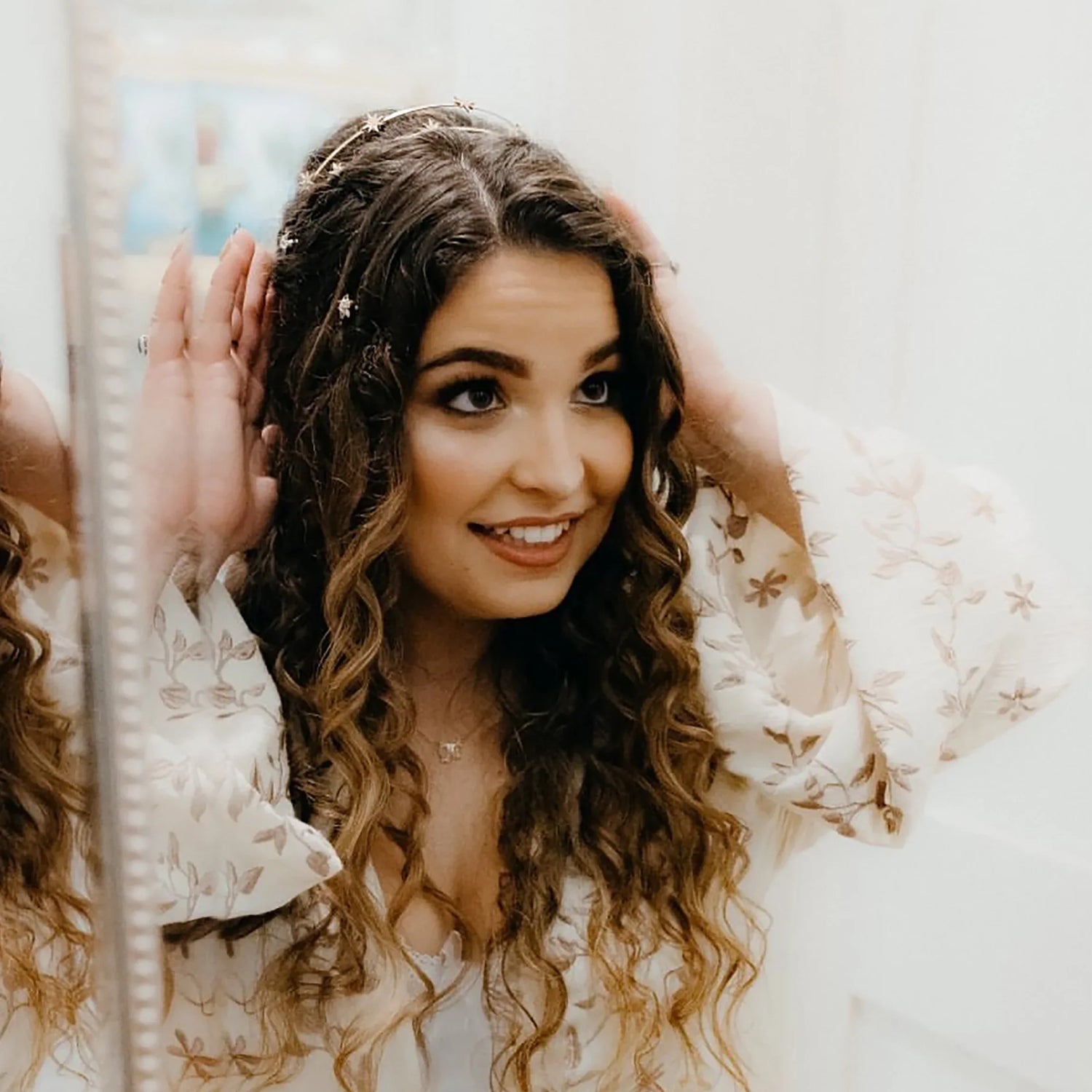 Bride wearing a white lace veil and crystal bridal headpiece