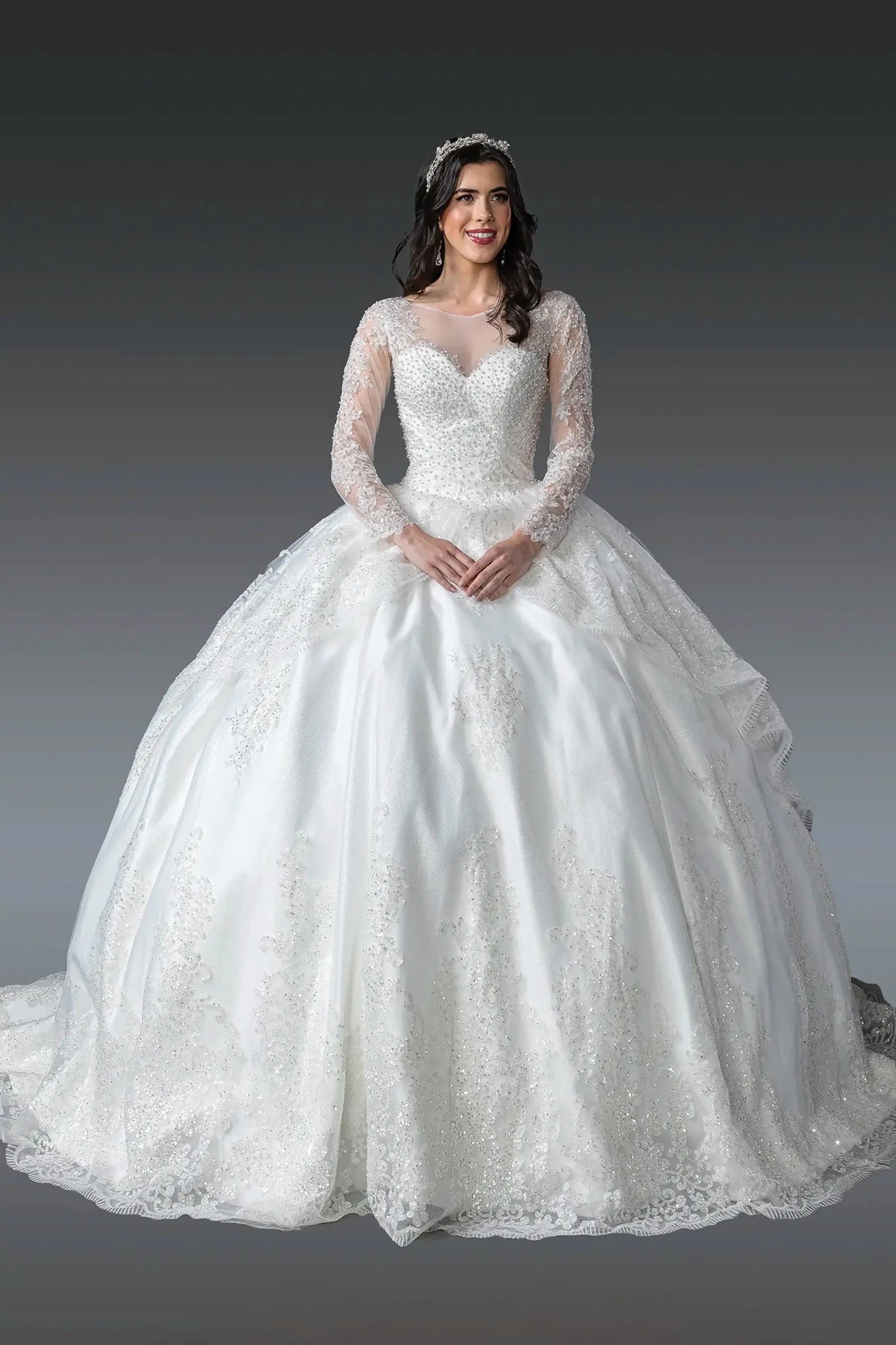 Woman in Off white long-sleeve wedding ball gown with beaded lace details.