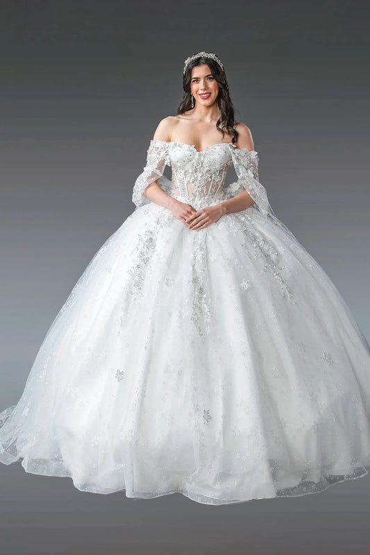 Woman in a white ball gown dress with floral details on a gray background