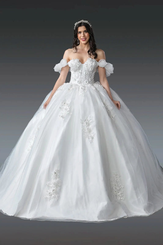 Woman in Off white puff sleeve ball gown dress with 3D florals and lace-up back.