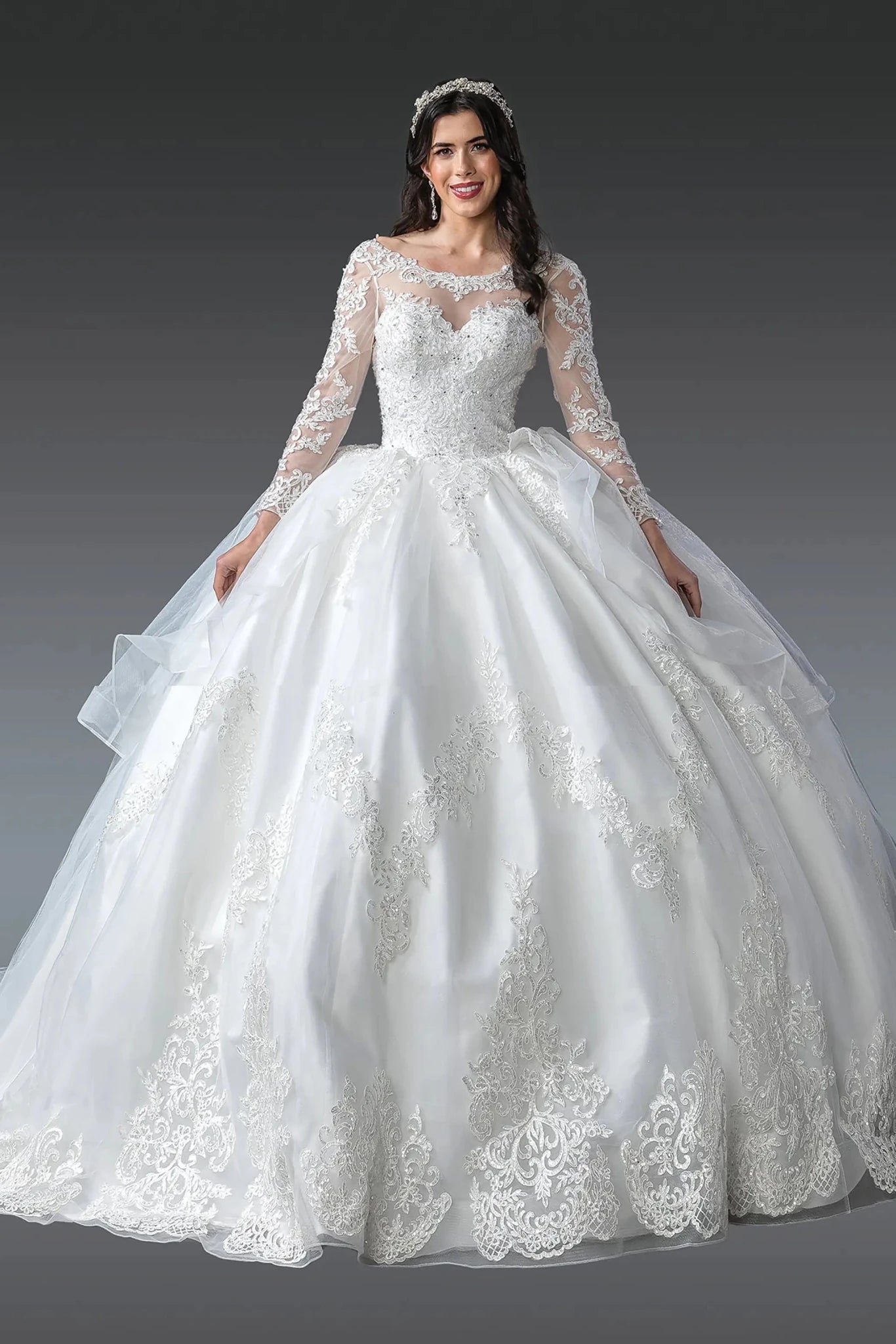 Woman in Off white long sleeve lace wedding gown with illusion neckline and full skirt.