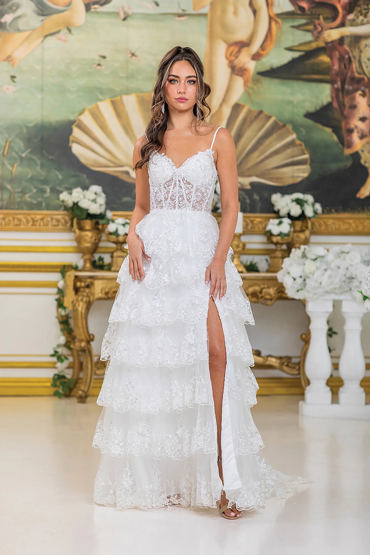 Showing a tiered lace skirt with a high slit, this Off-White wedding dress is shown in full view.