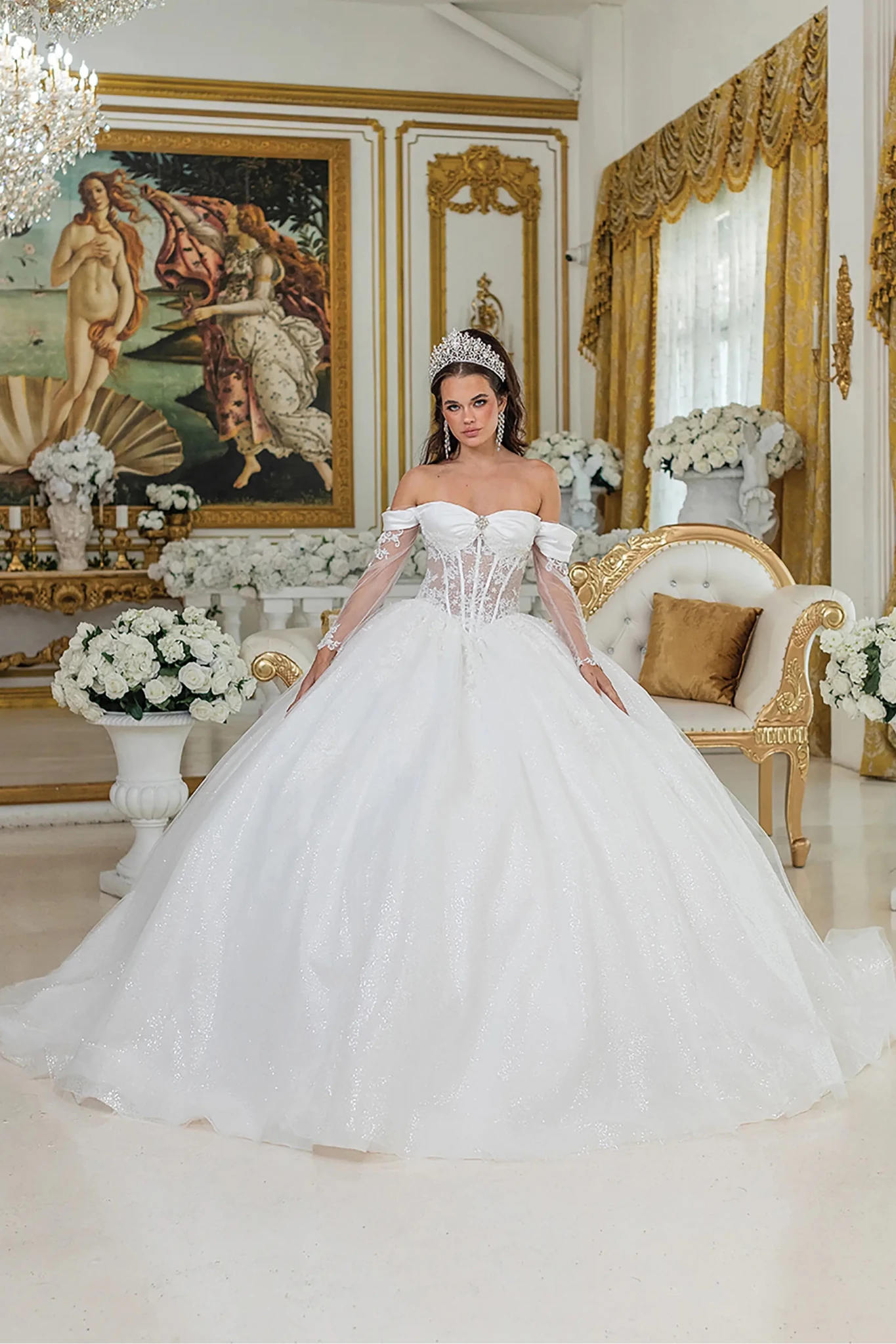 Woman in Off white off-shoulder wedding ball gown with sheer corset and glitter skirt.