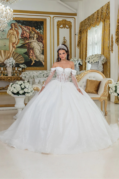 Woman in Off white off-shoulder wedding ball gown with sheer corset and glitter skirt.