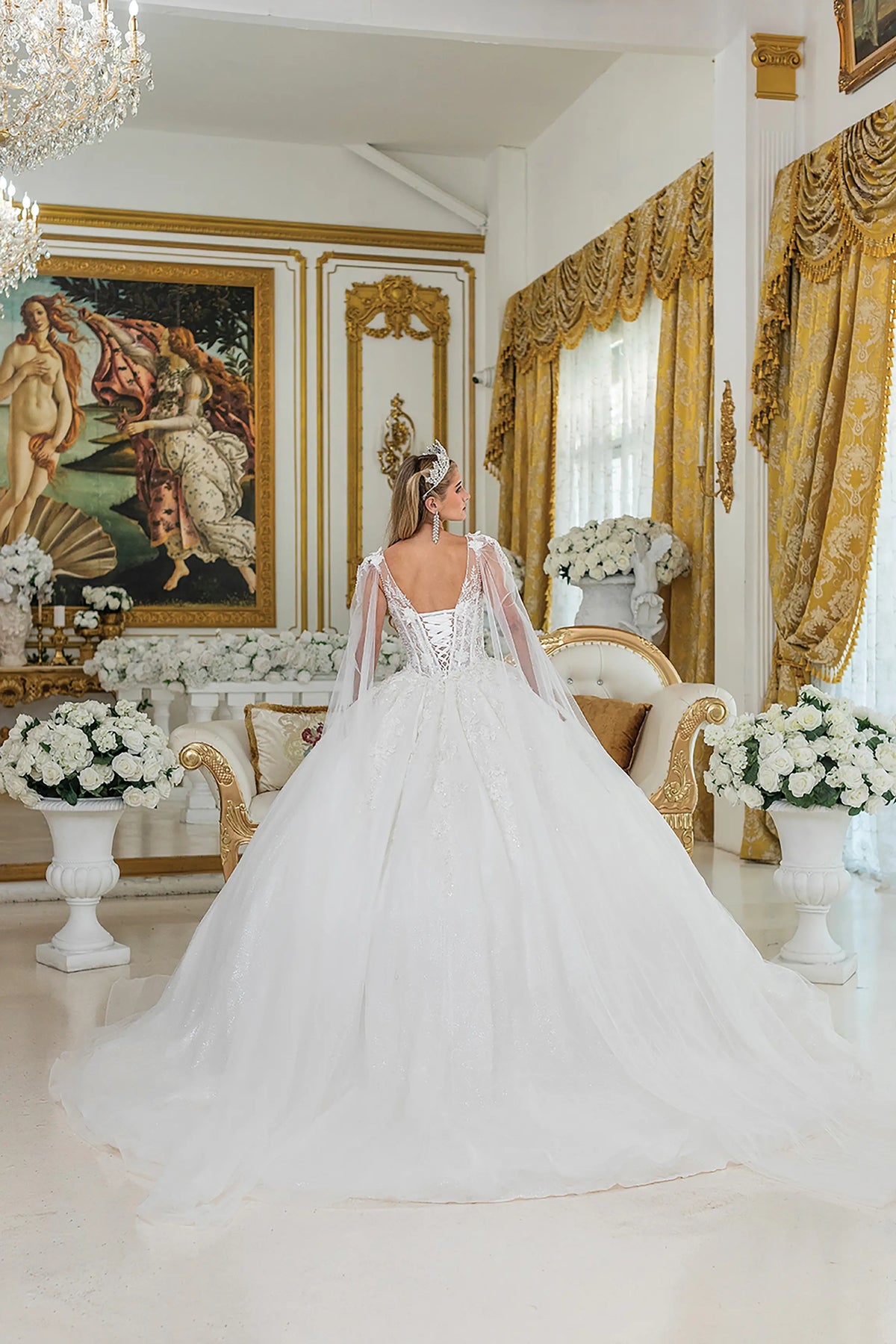 Revealing a lace-up back and sweeping ball-gown train, this Off-White wedding dress is shown from the back.