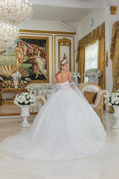 Bride in a white wedding dress standing in an opulent room with decorative elements.