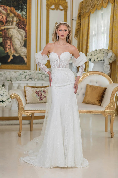 Woman in Off white mermaid wedding dress with sheer lace bodice and puff sleeves.