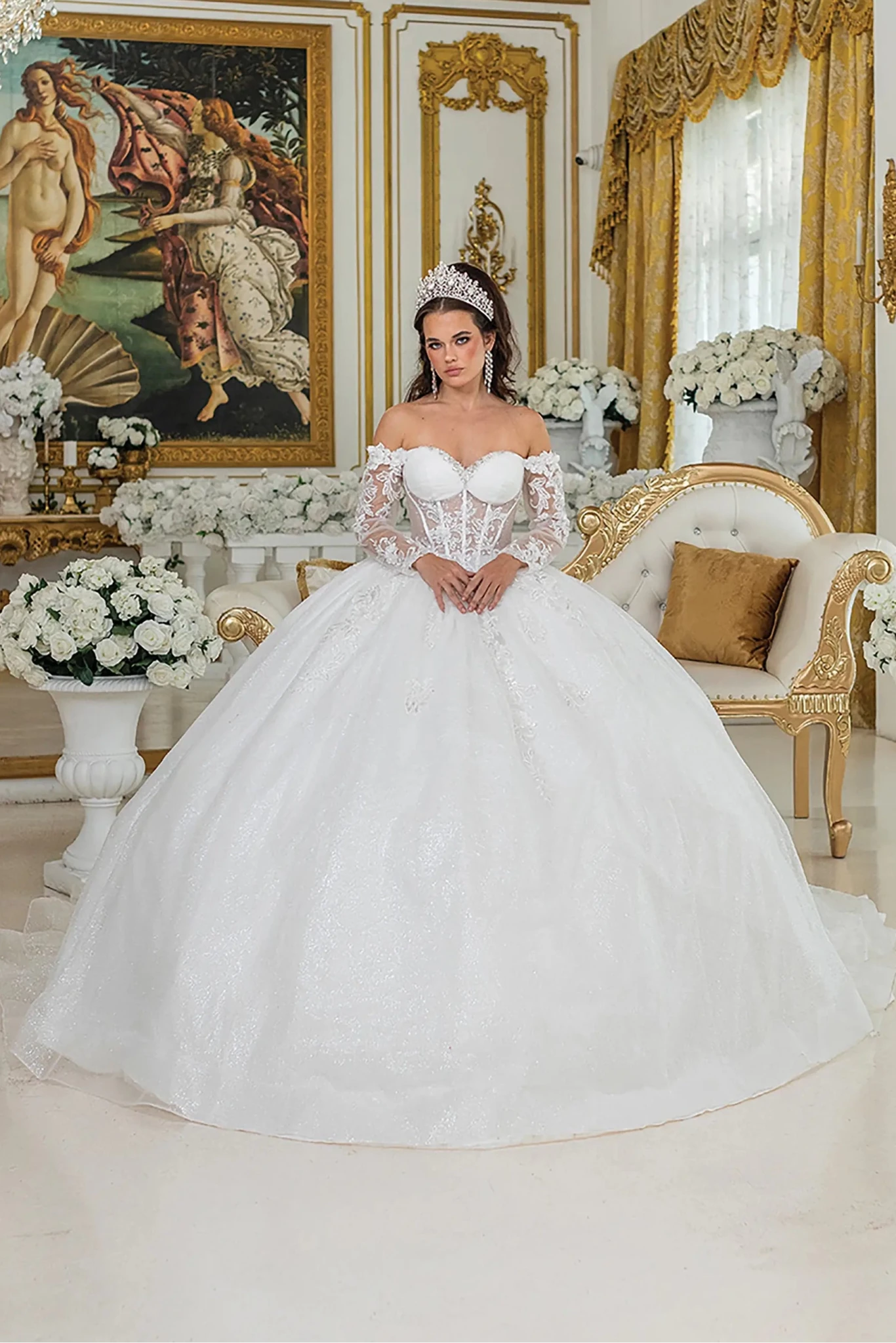 Woman in Off white ball gown wedding dress with lace sleeves and corset bodice.