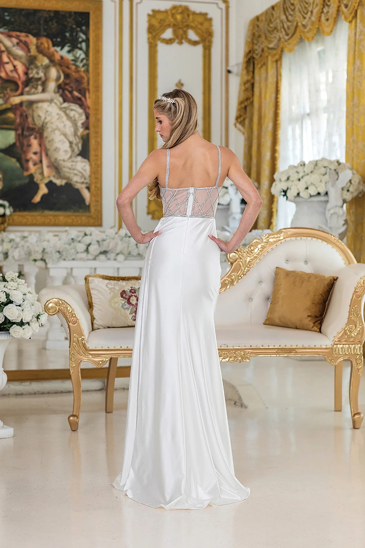 Revealing a lace-up bodice and satin train, this Off-White wedding dress is shown from the back.