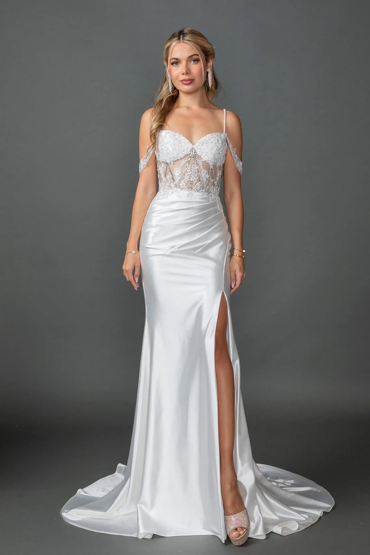 Showing an embellished sweetheart bodice and high slit, this Off-White wedding dress is shown in full view.