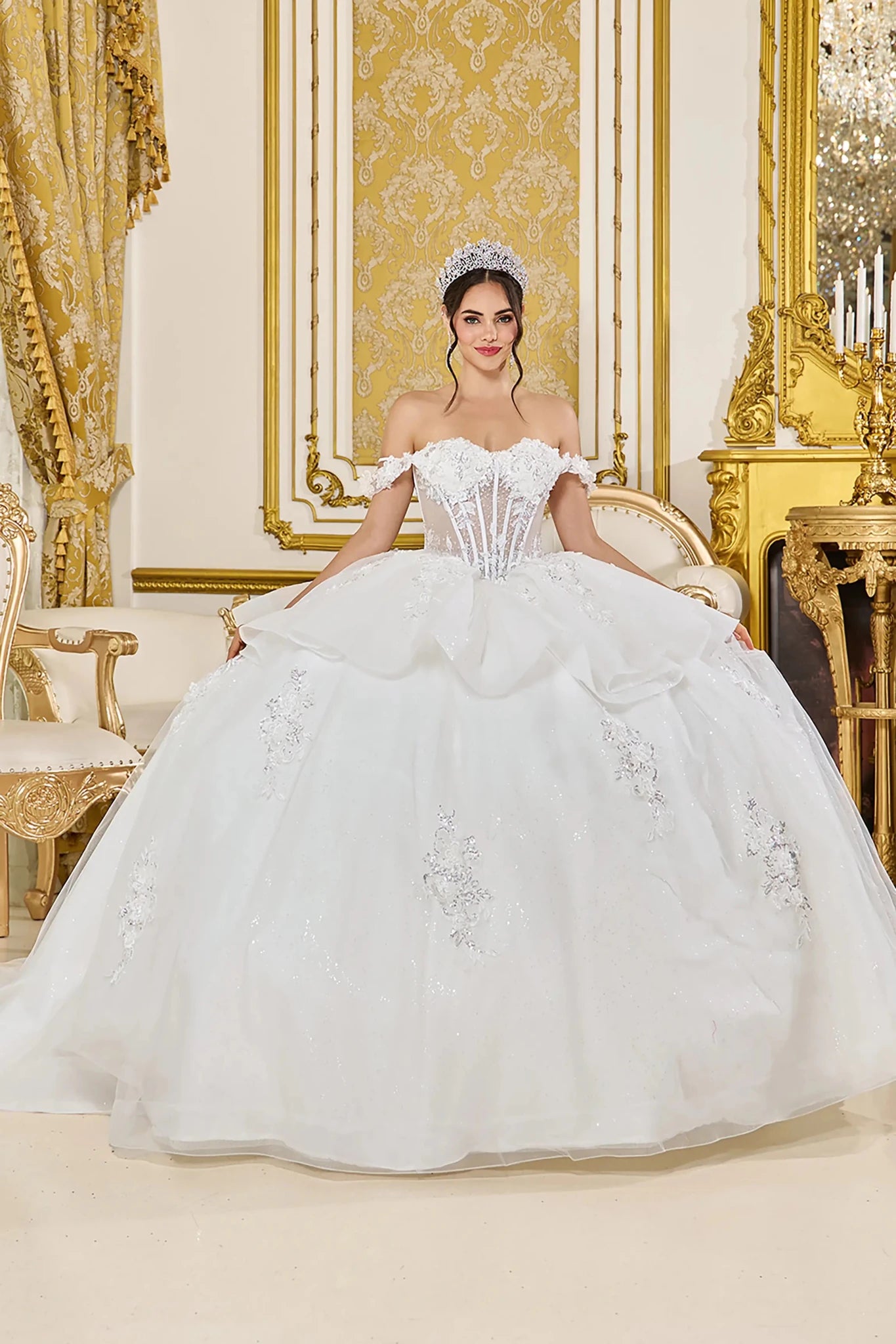 Woman in Off white off-shoulder wedding ball gown with floral corset and layered skirt.