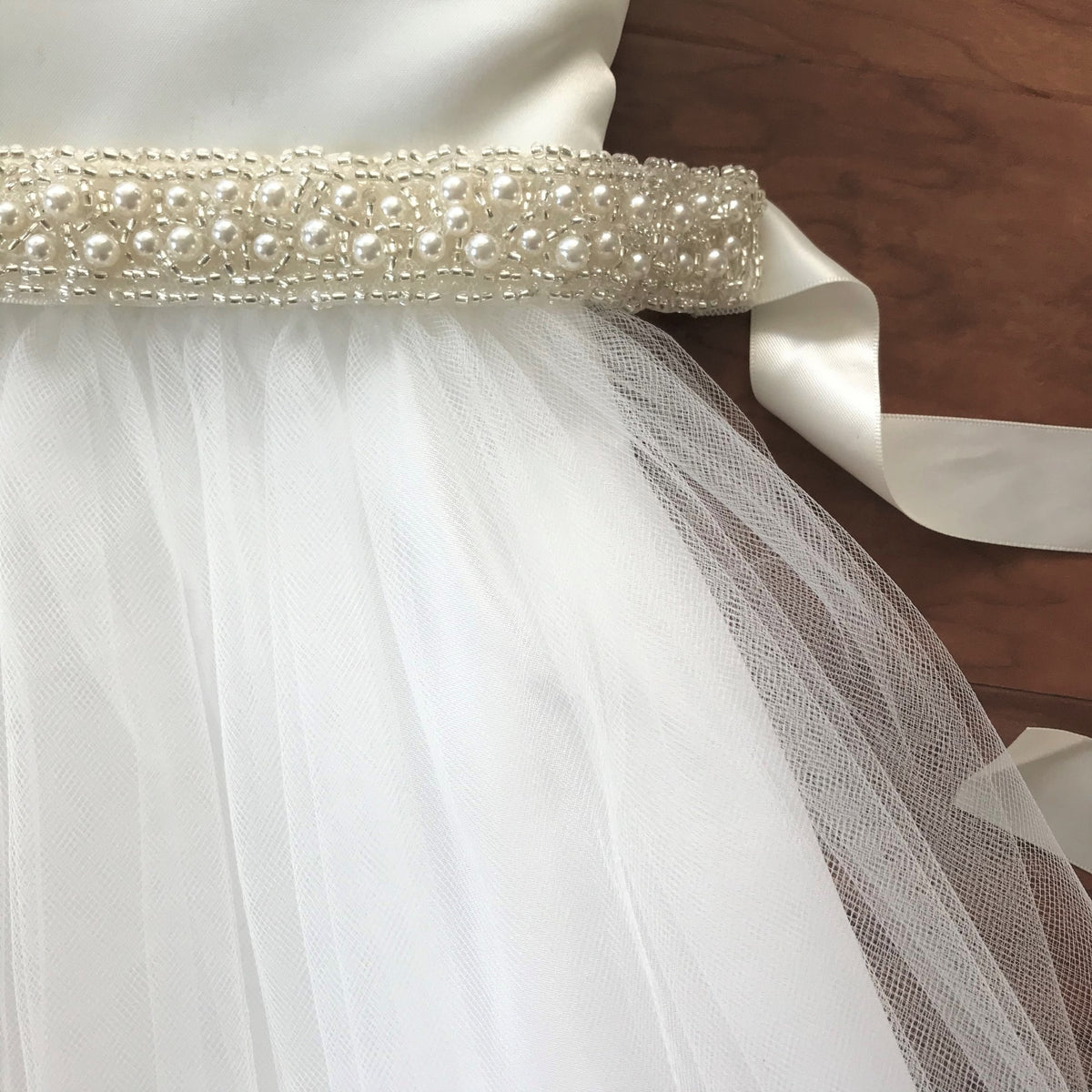 Ivory pearl satin flower girl headband, close-up, embellishment detail.