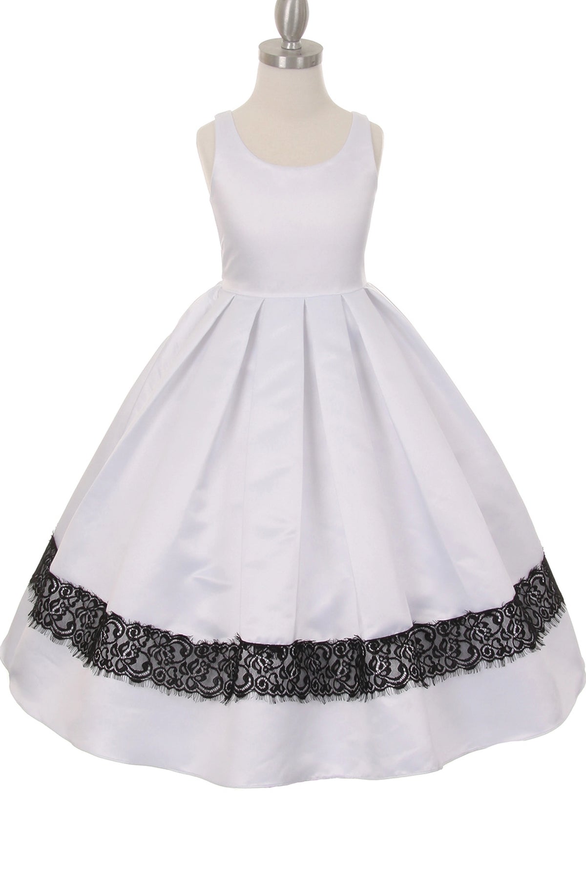 White flower girl dress features black lace trim beneath a pleated skirt.