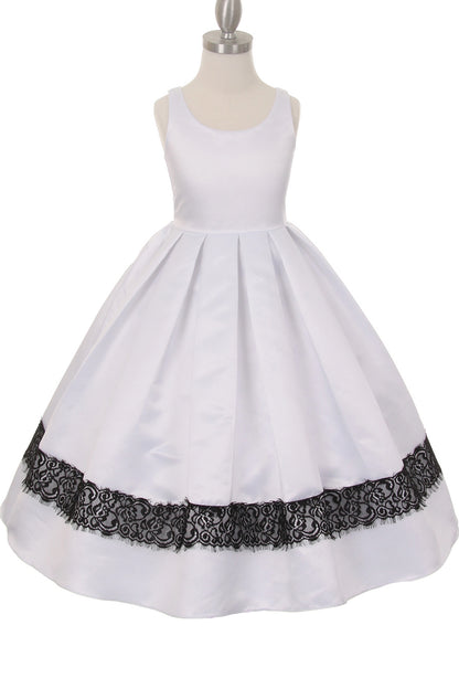 White flower girl dress features black lace trim beneath a pleated skirt.