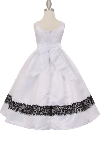A White flower girl dress showing large back sash bow above the pleated skirt.