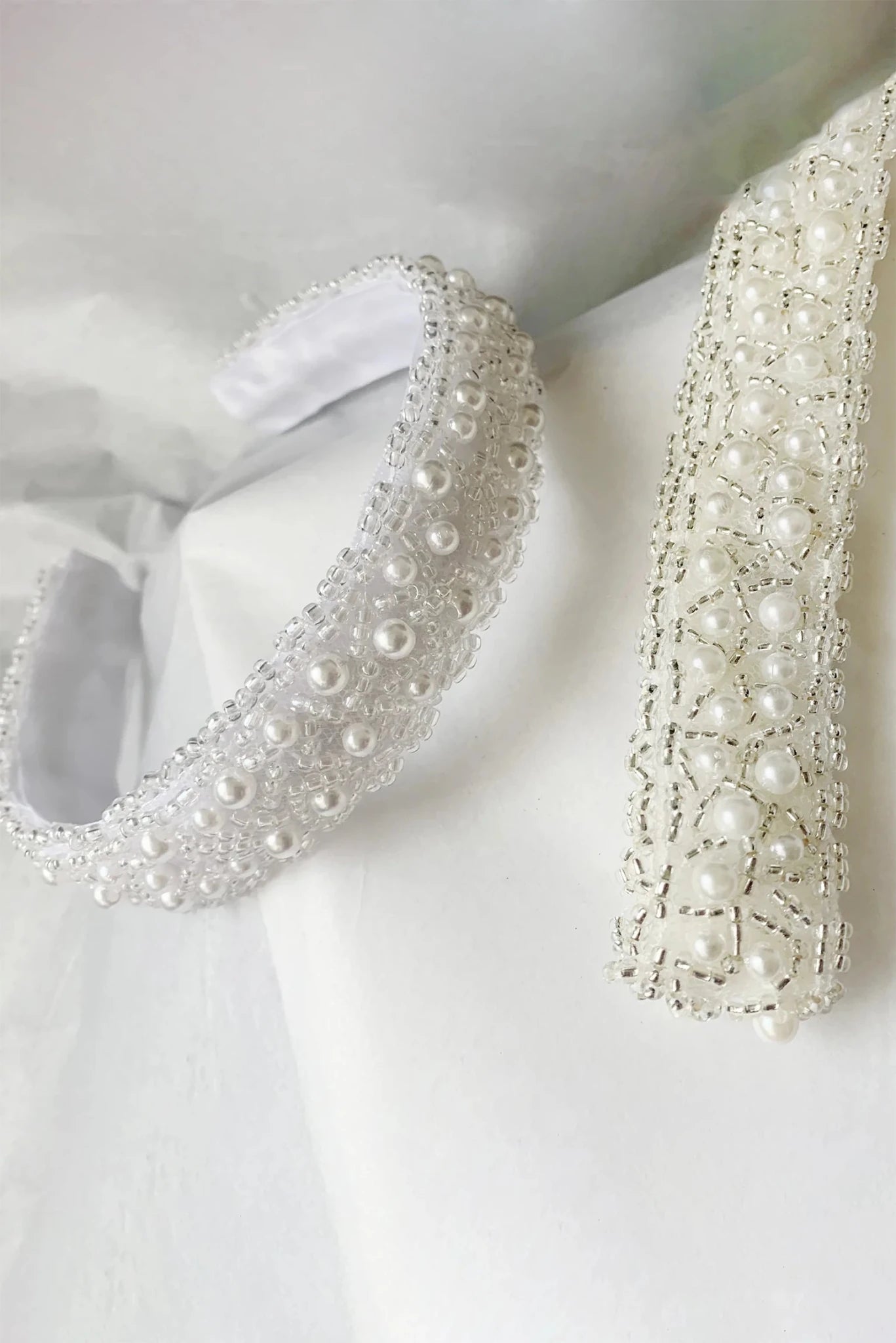 handmade p earl embellished headband and sash on a white background