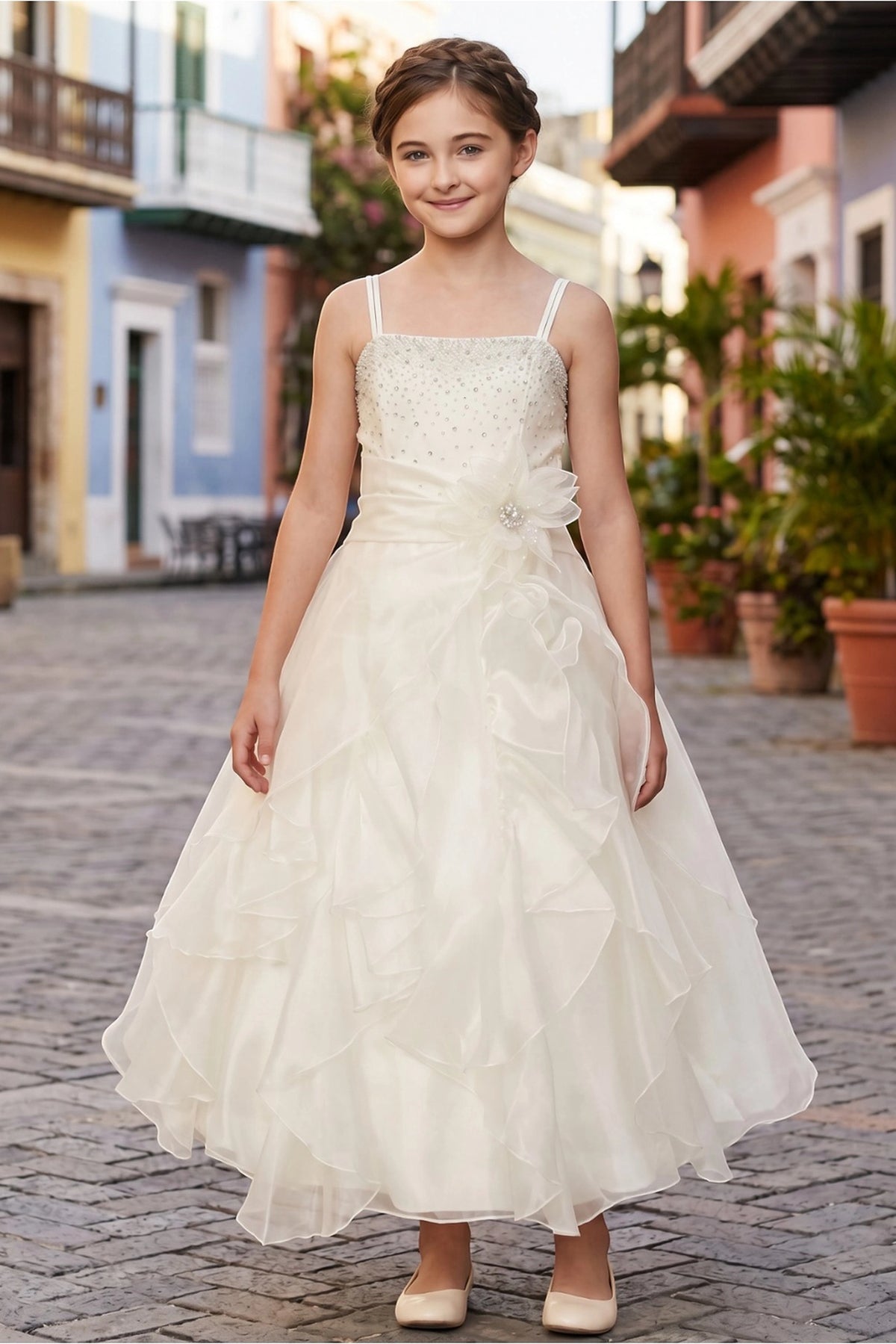 Ivory mini quince dress with a flower waist accent and cascading ruffles.