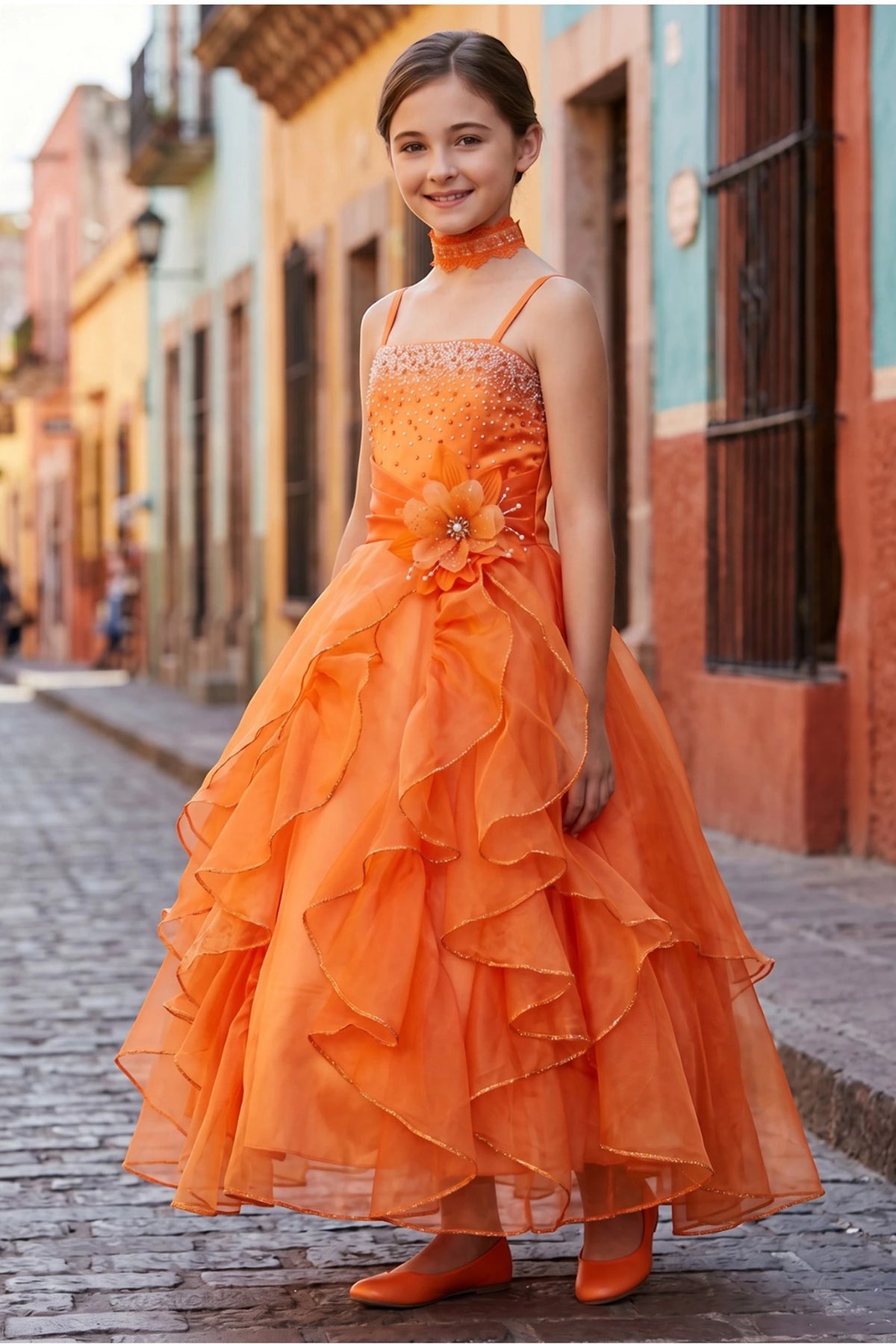 Orange mini quince dress with cascading ruffles and a waist flower.