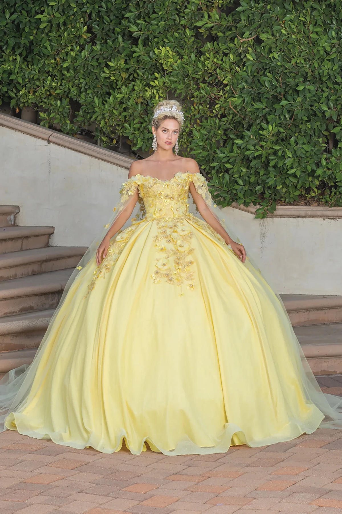 off-the-shoulder yellow quinceanera ball gown with floral applique, sheer cape and a full tulle skirt