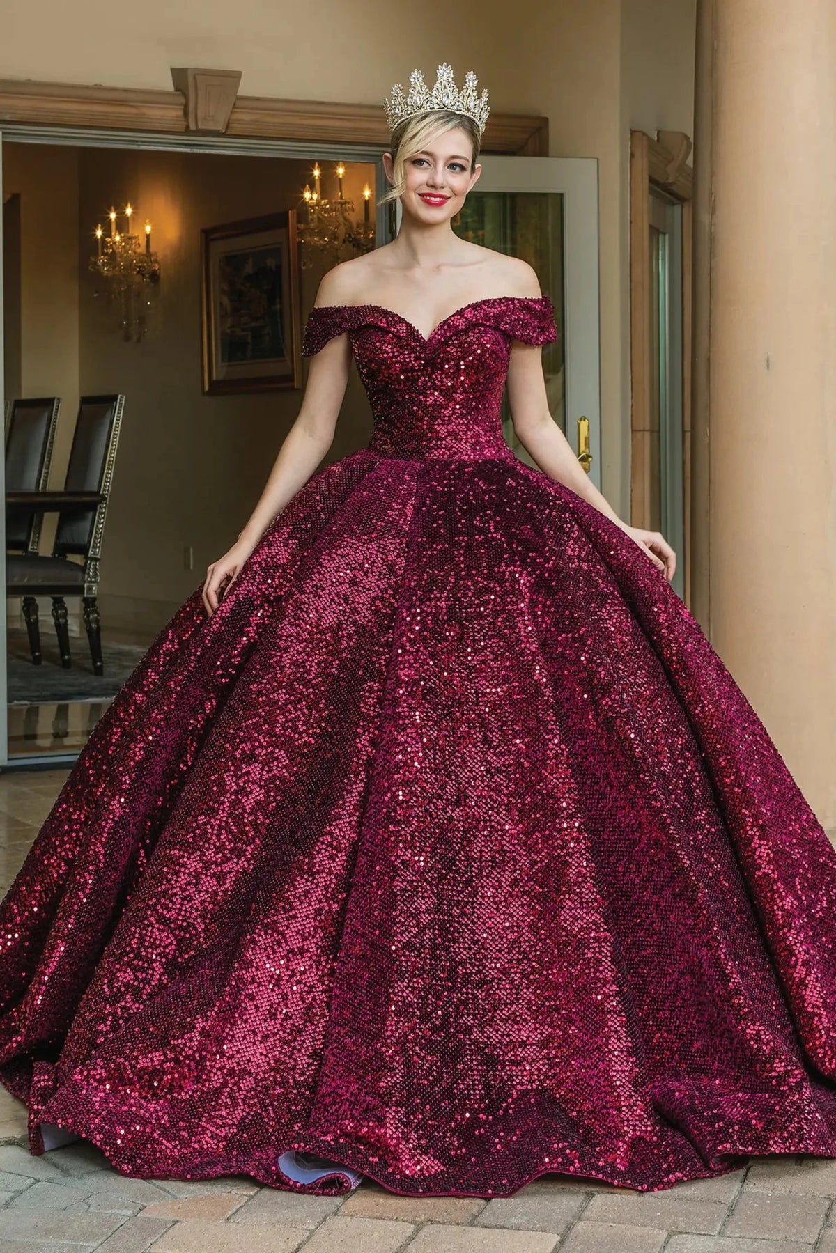Front view of a Fuchsia quinceañera gown with off-the-shoulder neckline, heart-shaped bodice, and crystal accents
