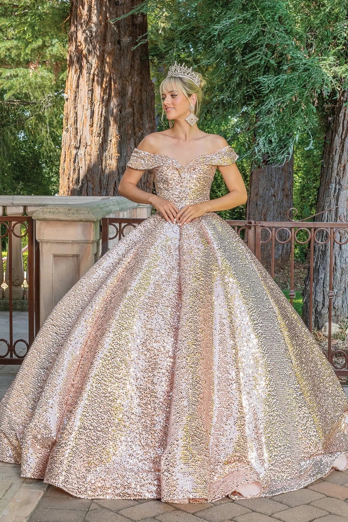 Front view of a Rose Gold quinceañera gown with off-the-shoulder neckline, heart-shaped bodice, and crystal accents