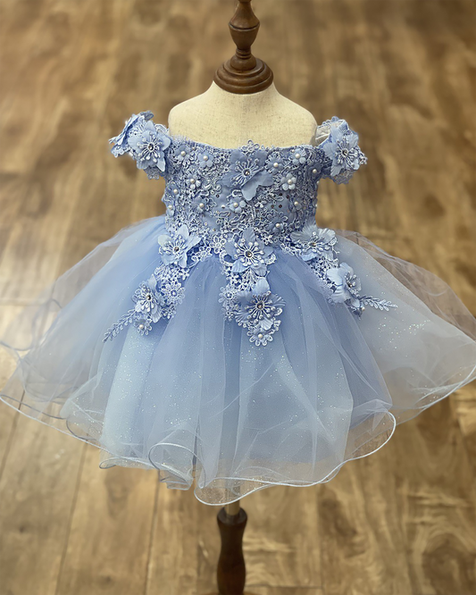 Light Blue floral dress on a mannequin against a wooden floor background