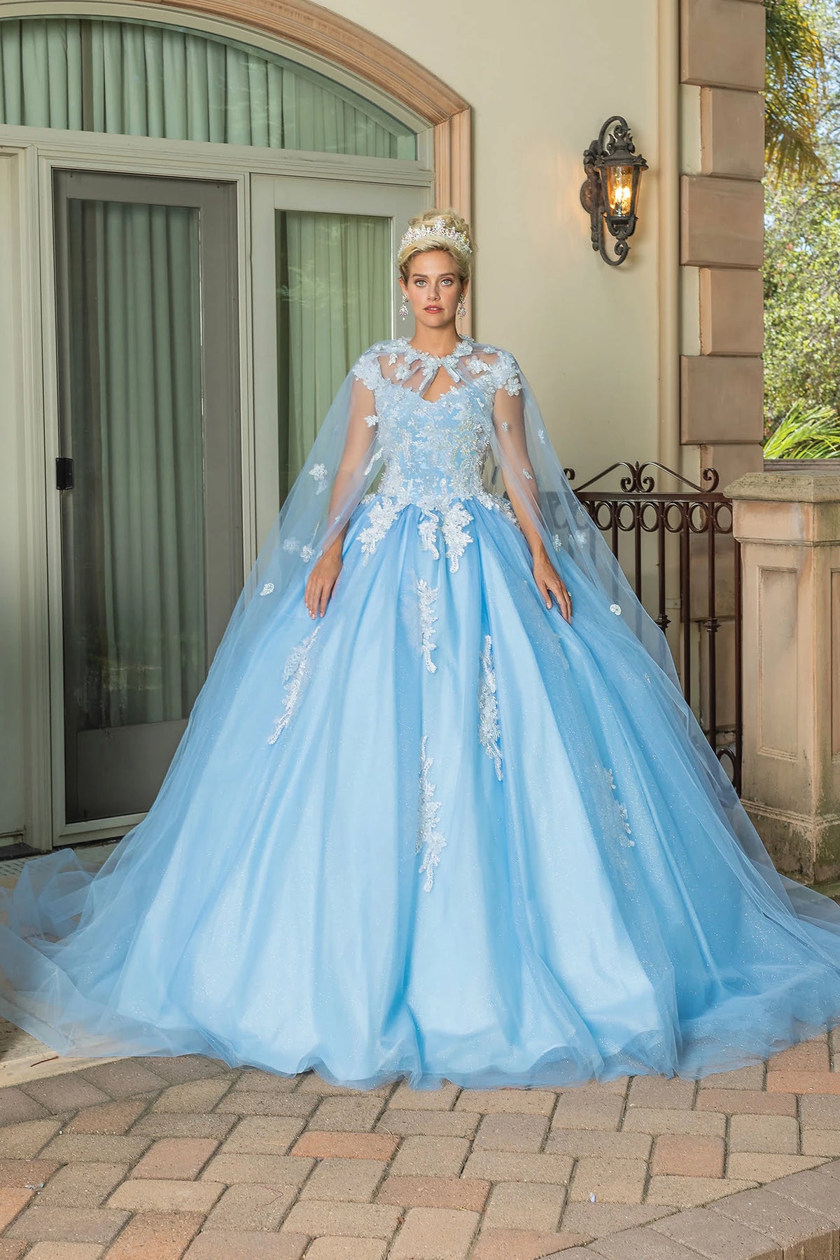 Featuring a floor-length skirt, this Bahama Blue quinceañera ball gown is shown in full view.