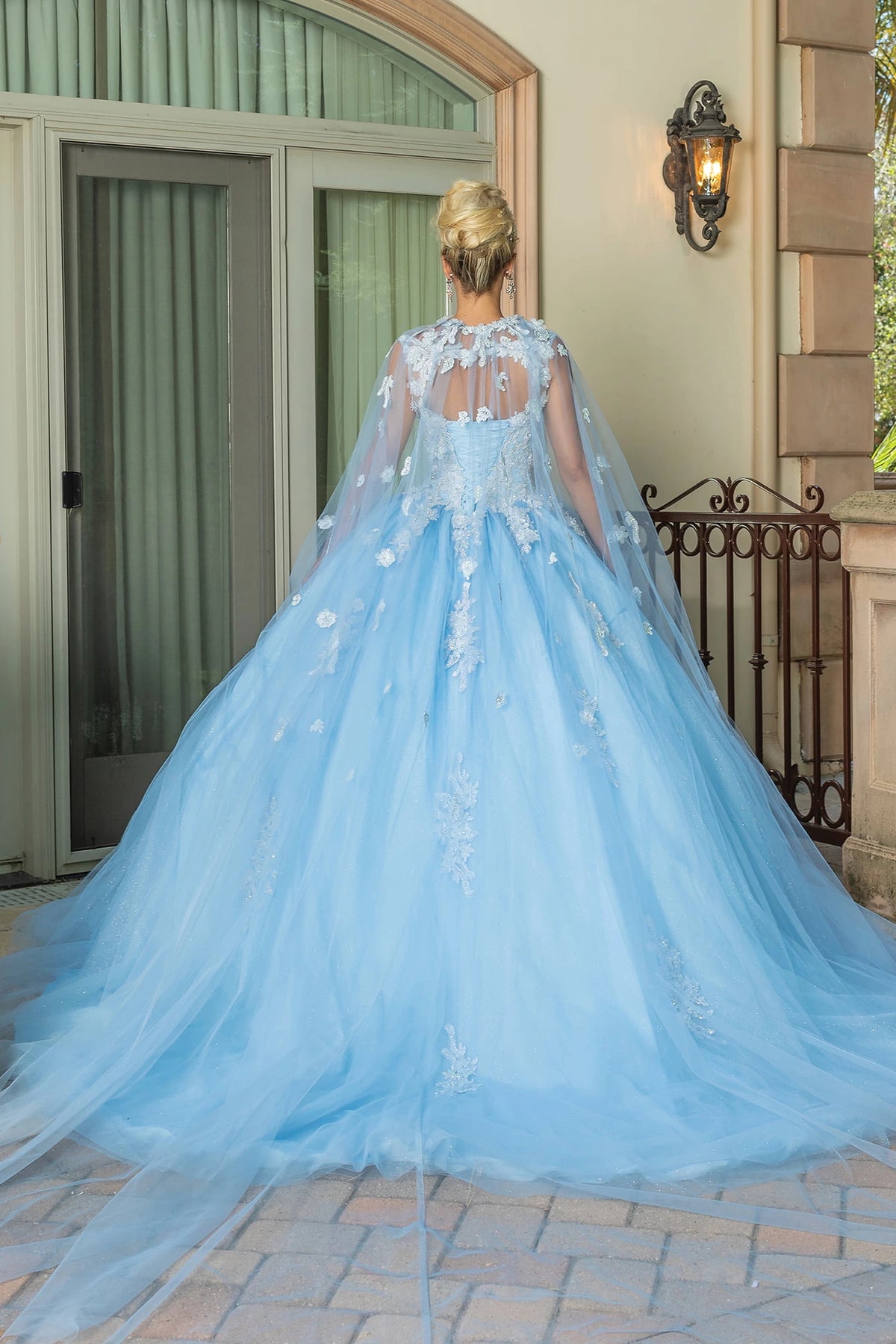 Showing its floor-length skirt, the Bahama Blue quinceañera ball gown highlights the garment construction.