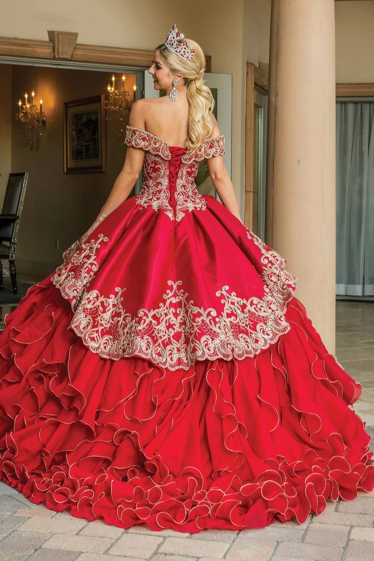 Back view of a Burgundy quinceañera gown showing lace-up back, cascading ruffle skirt, and beaded embroidery