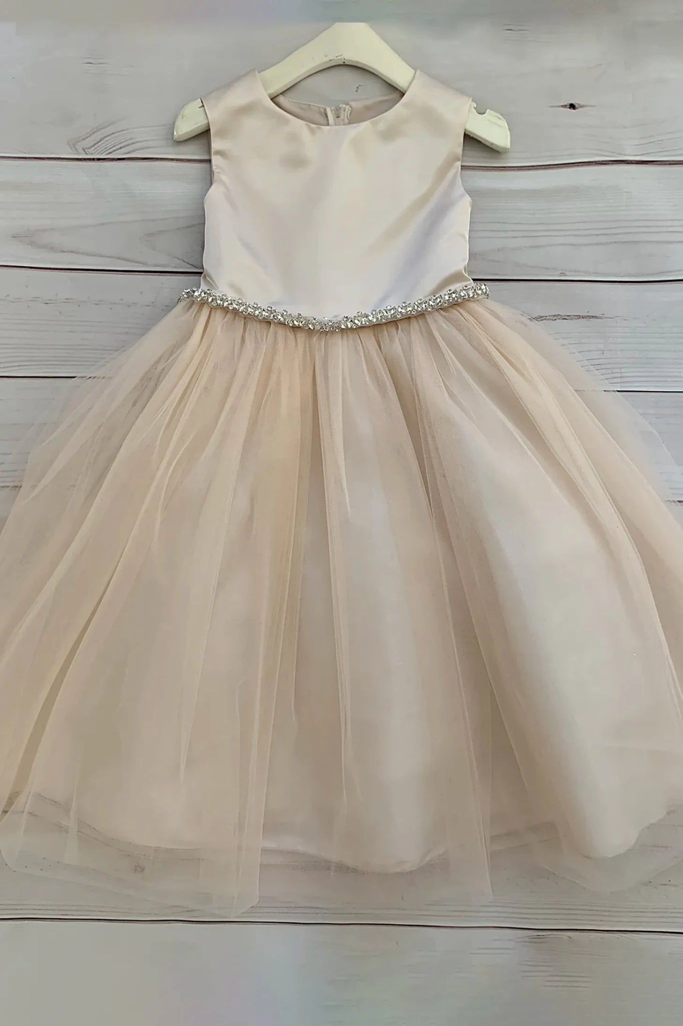 Champagne satin and tulle flower girl dress with rhinestone embellishment.