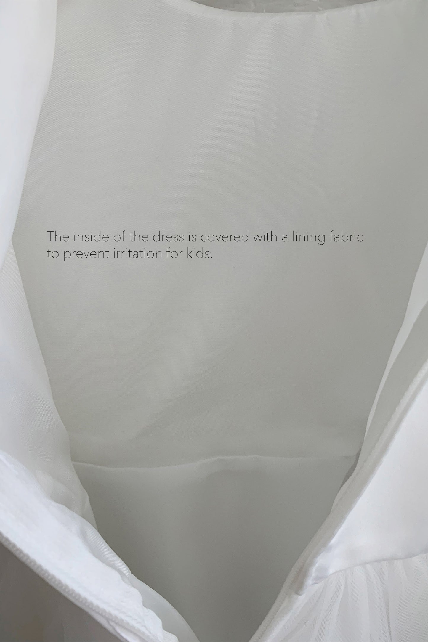 Close-up of a dress interior with lining fabric. Lining fabric to prevent irritation for kids.