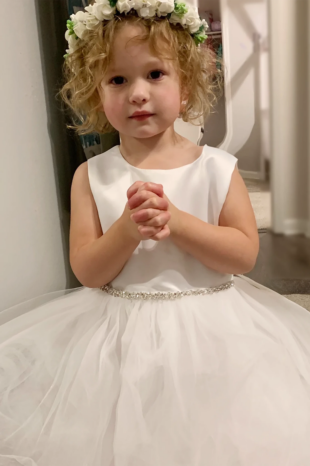 A tulle satin flower girl dress with rhinestone belt.