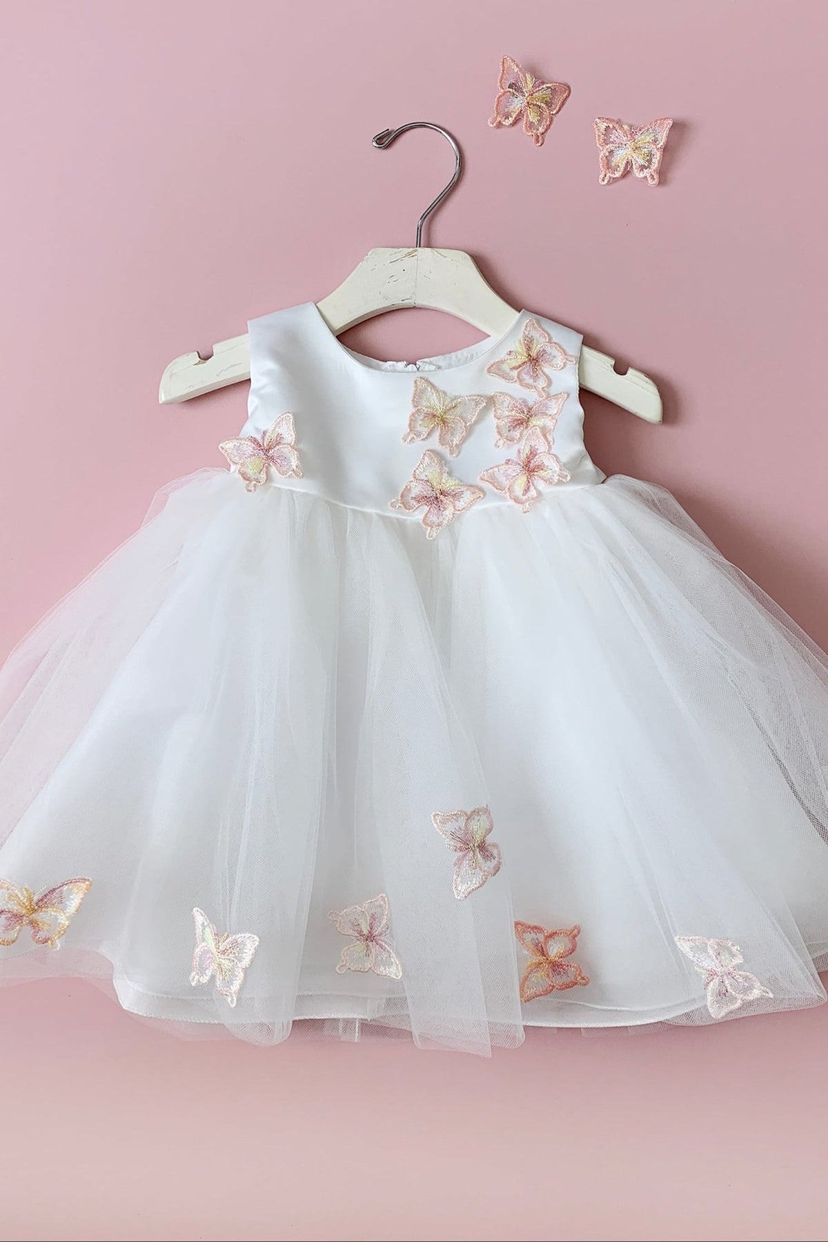 White flower girl dress with butterfly embroidery.