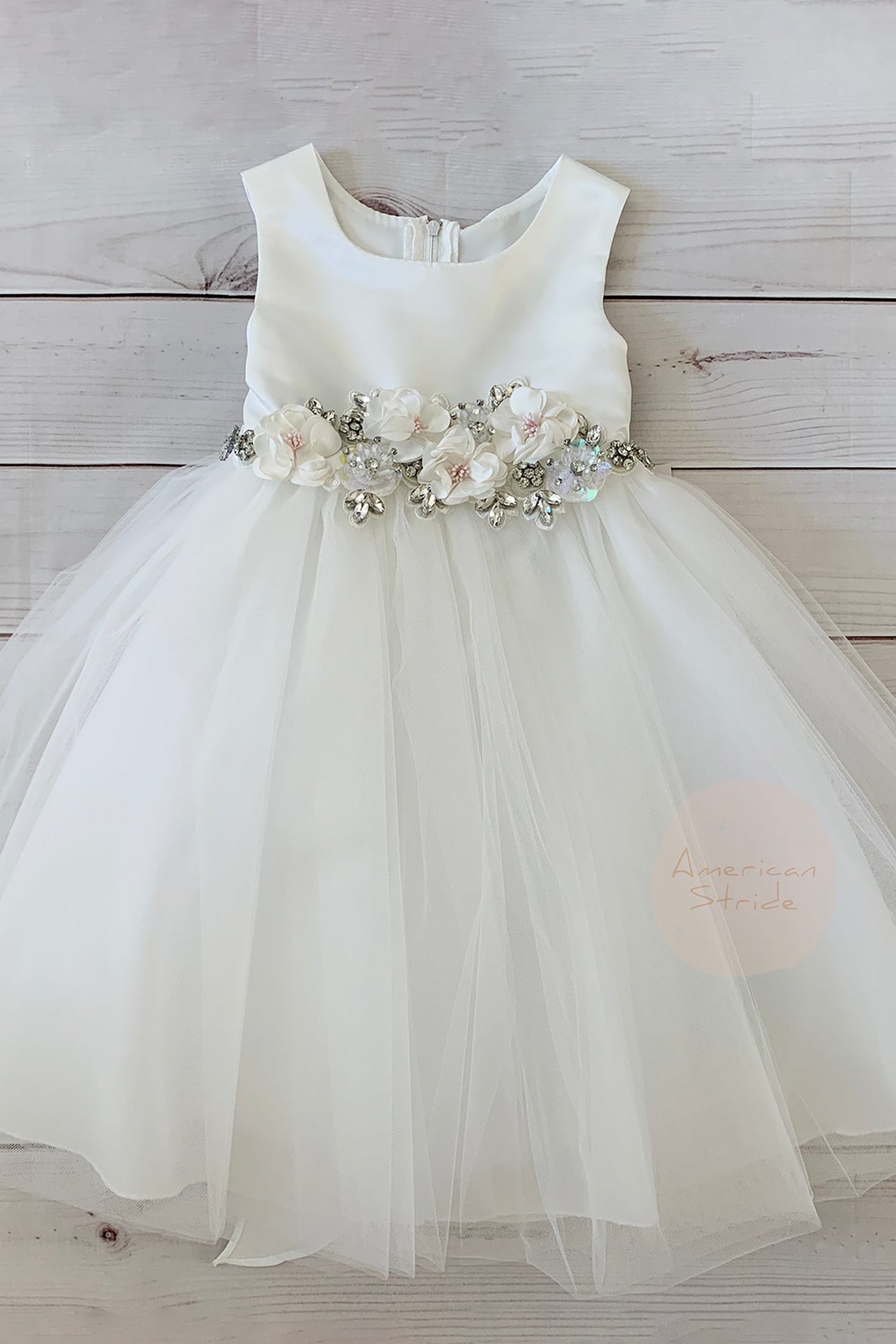 White flower girl dress with floral sash.