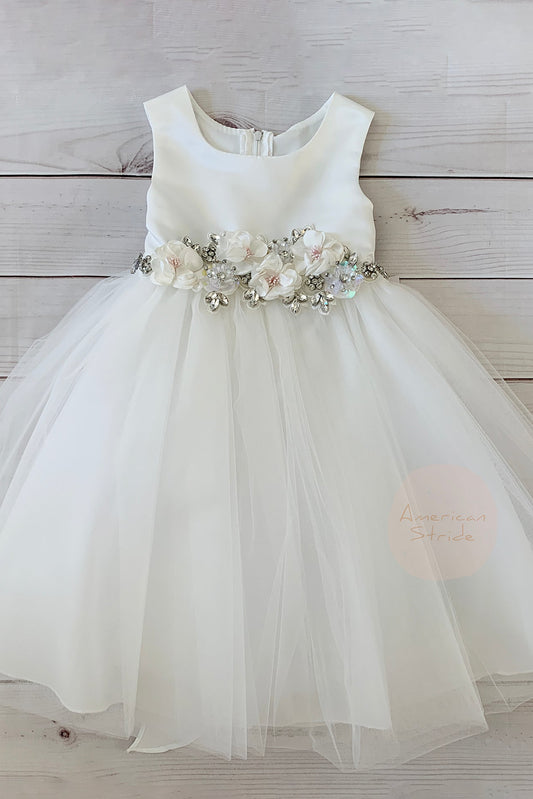 White flower girl dress with floral sash.