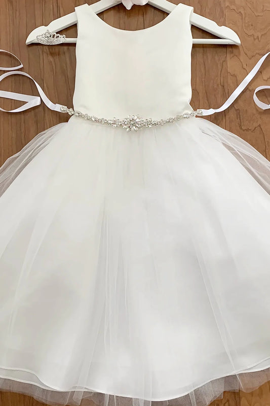 White flower girl dress with a rhinestone flower motif belt.