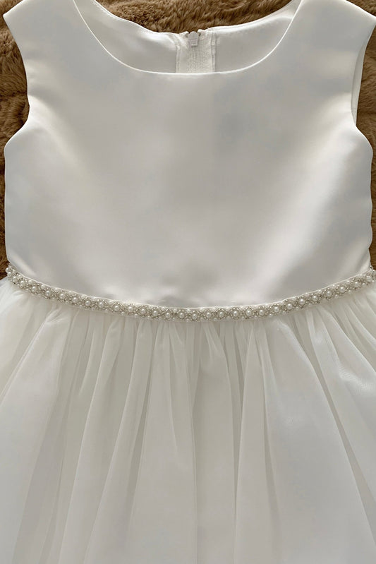 White flower girl dress with a pearl belt.