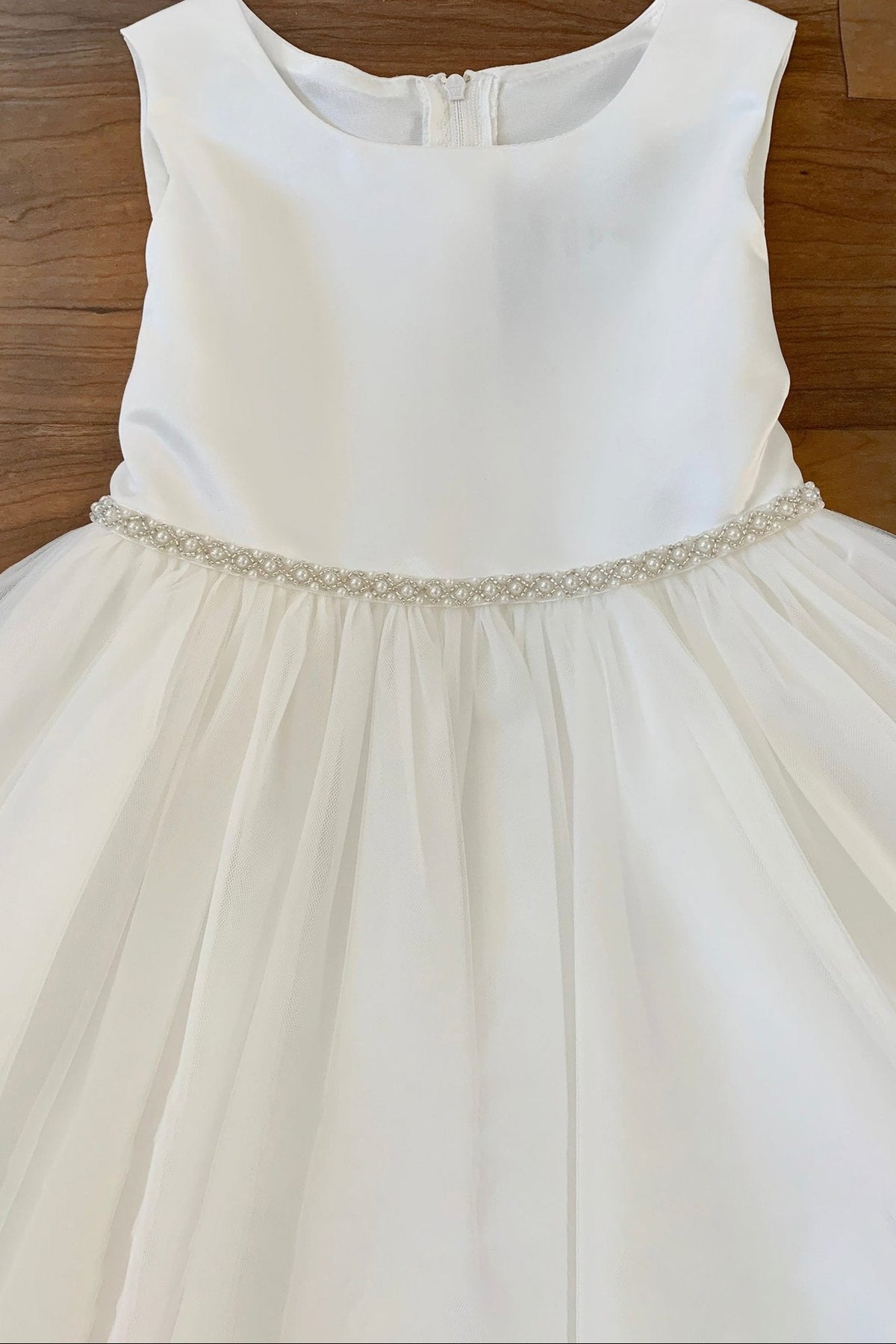 White flower girl dress with a pearl beaded waistband.