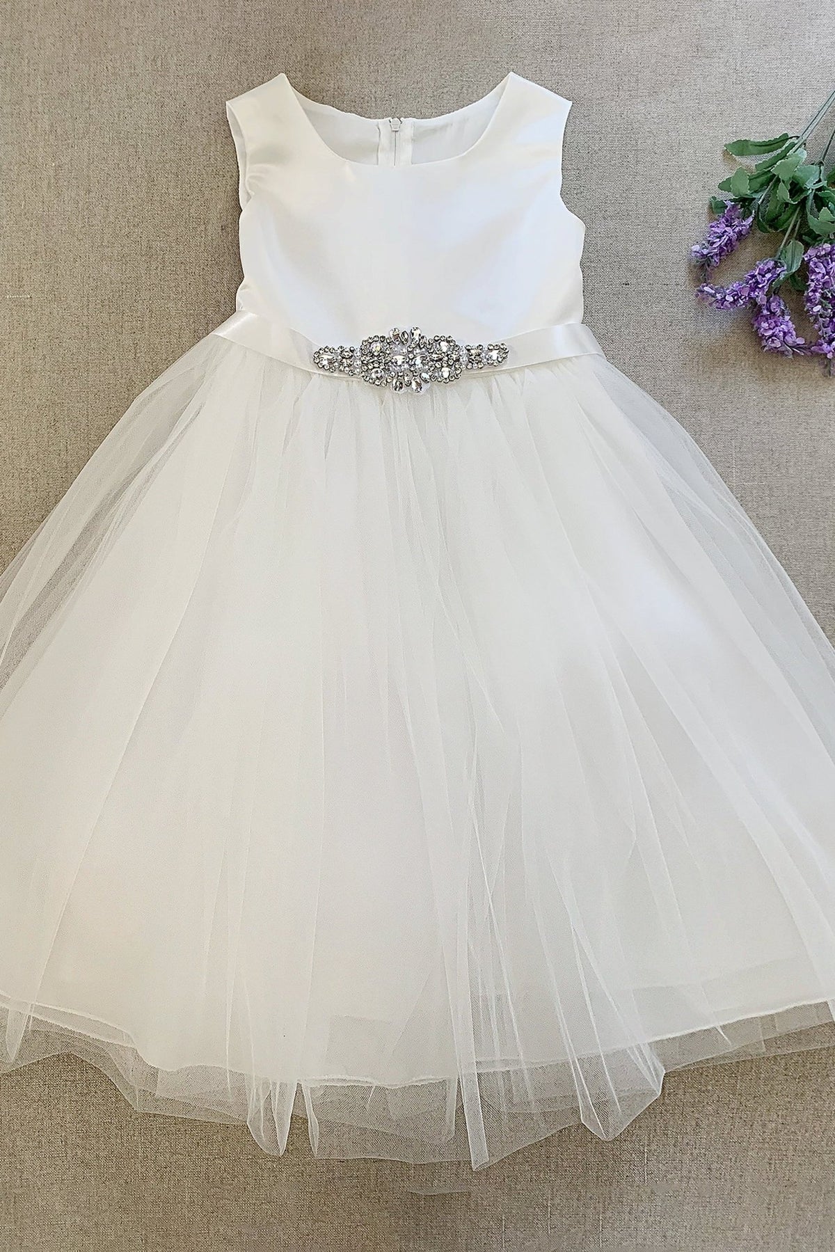 White flower girl dress with a silver belt.