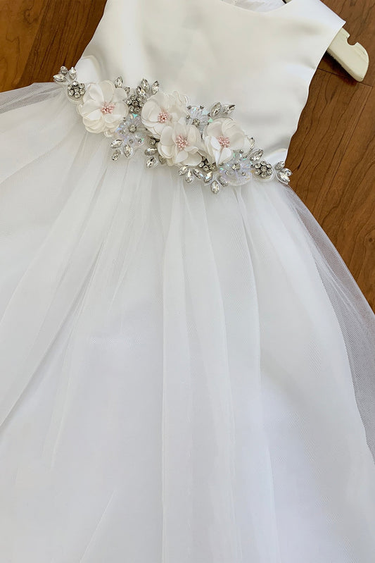 White flower girl dress with floral and crystal embellishments.