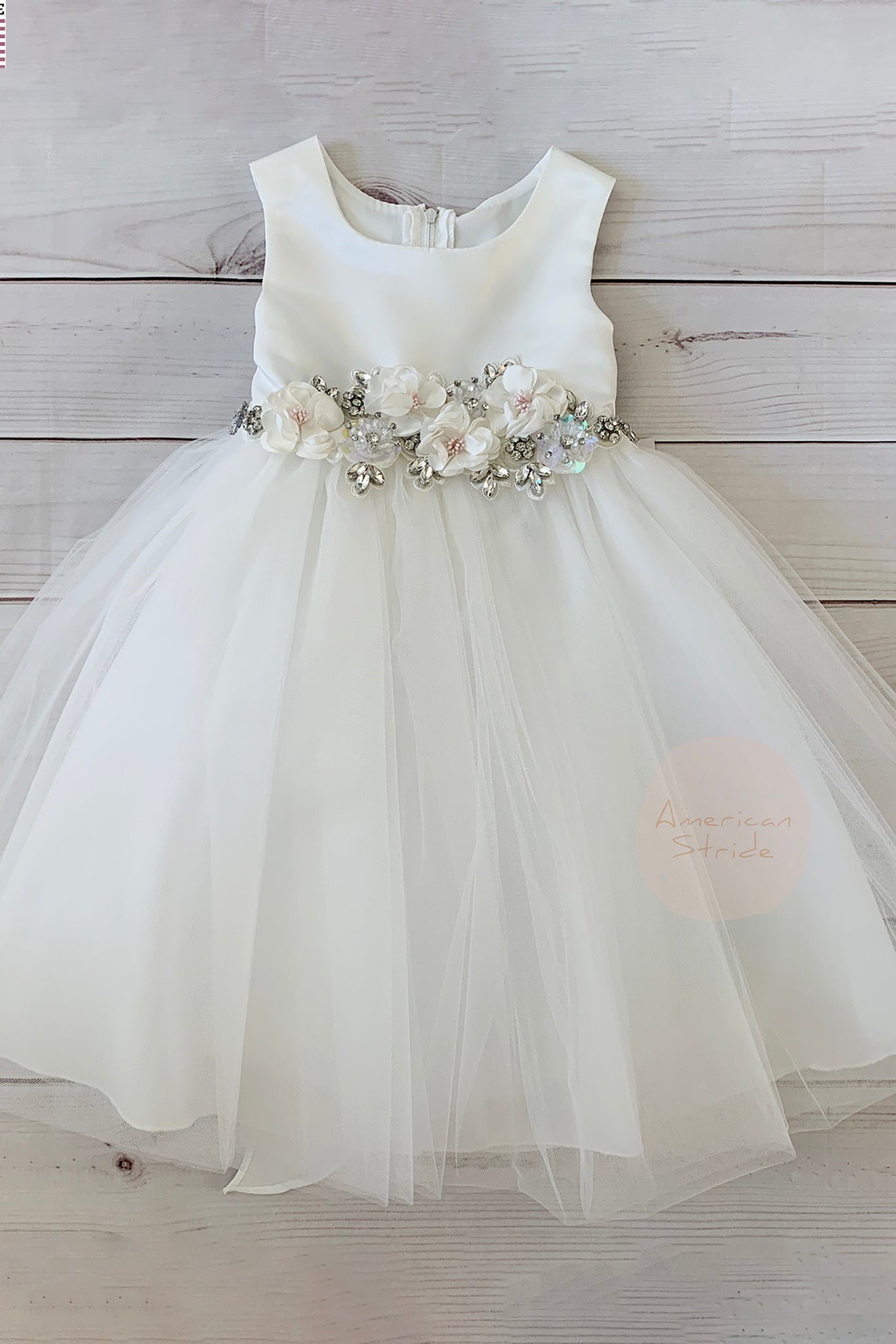 White flower girl dress with floral sash.