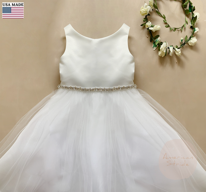 White dress with a beaded rhinestone waistband on a beige background