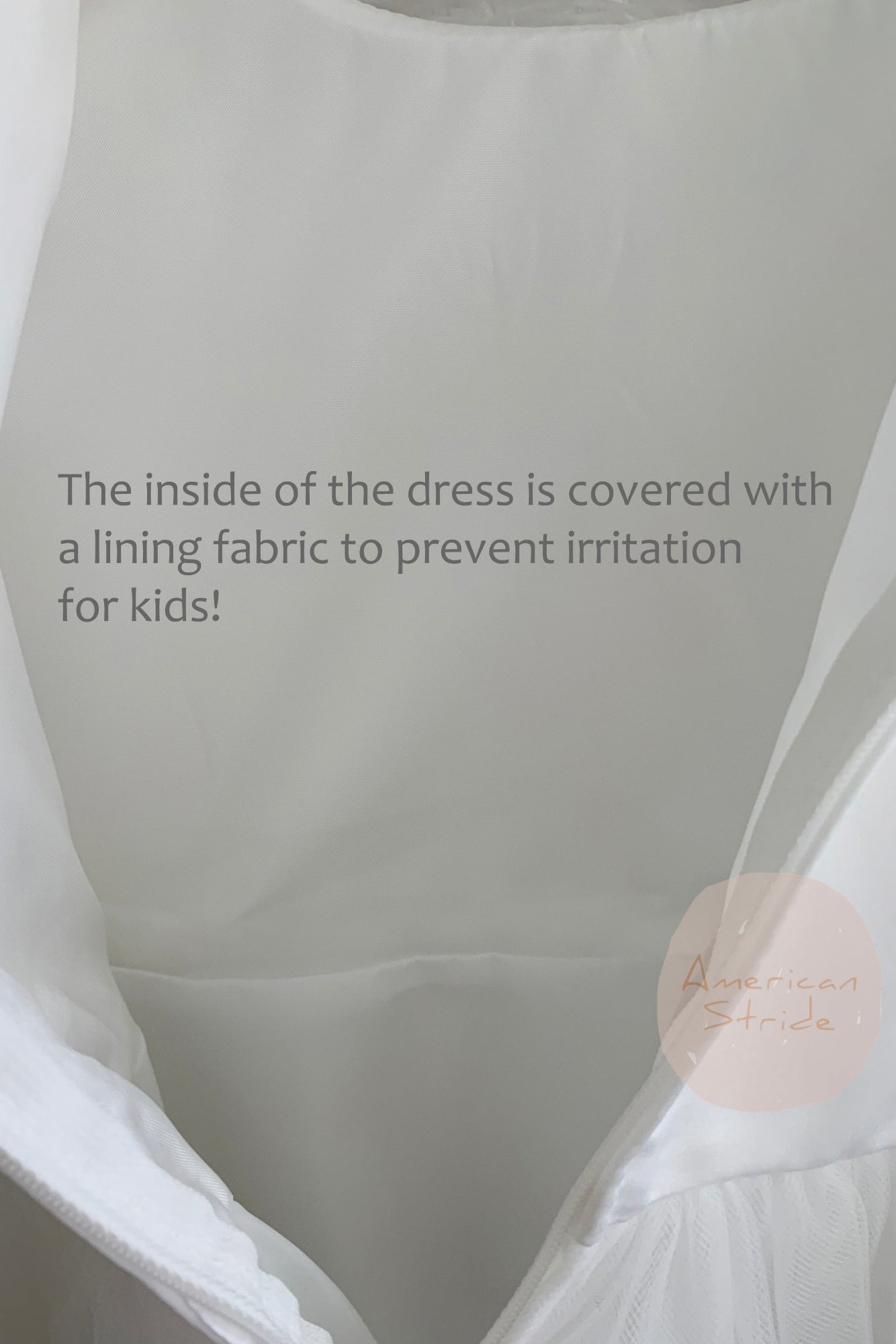 Close-up of a dress interior with lining fabric, featuring a brand logo.