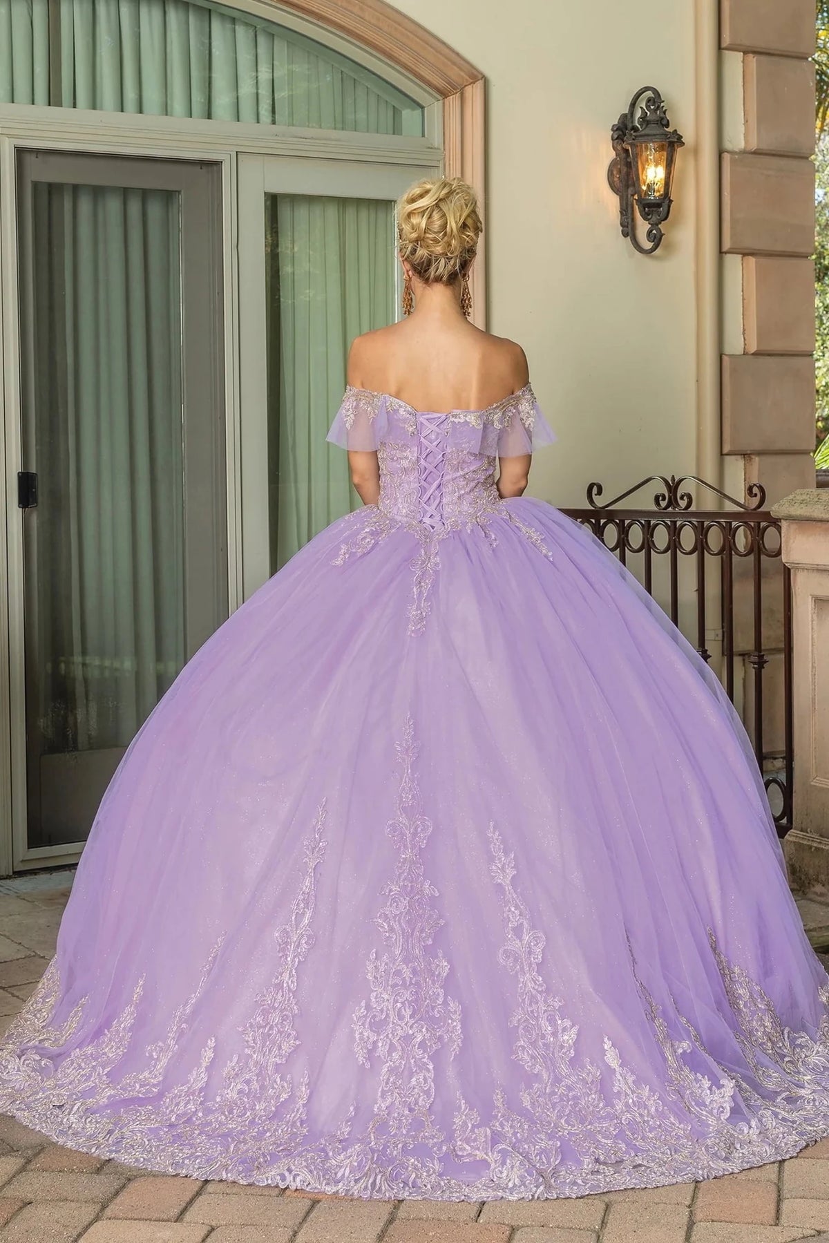 Back view of a Lilac quinceañera gown showing lace-up back and voluminous full skirt