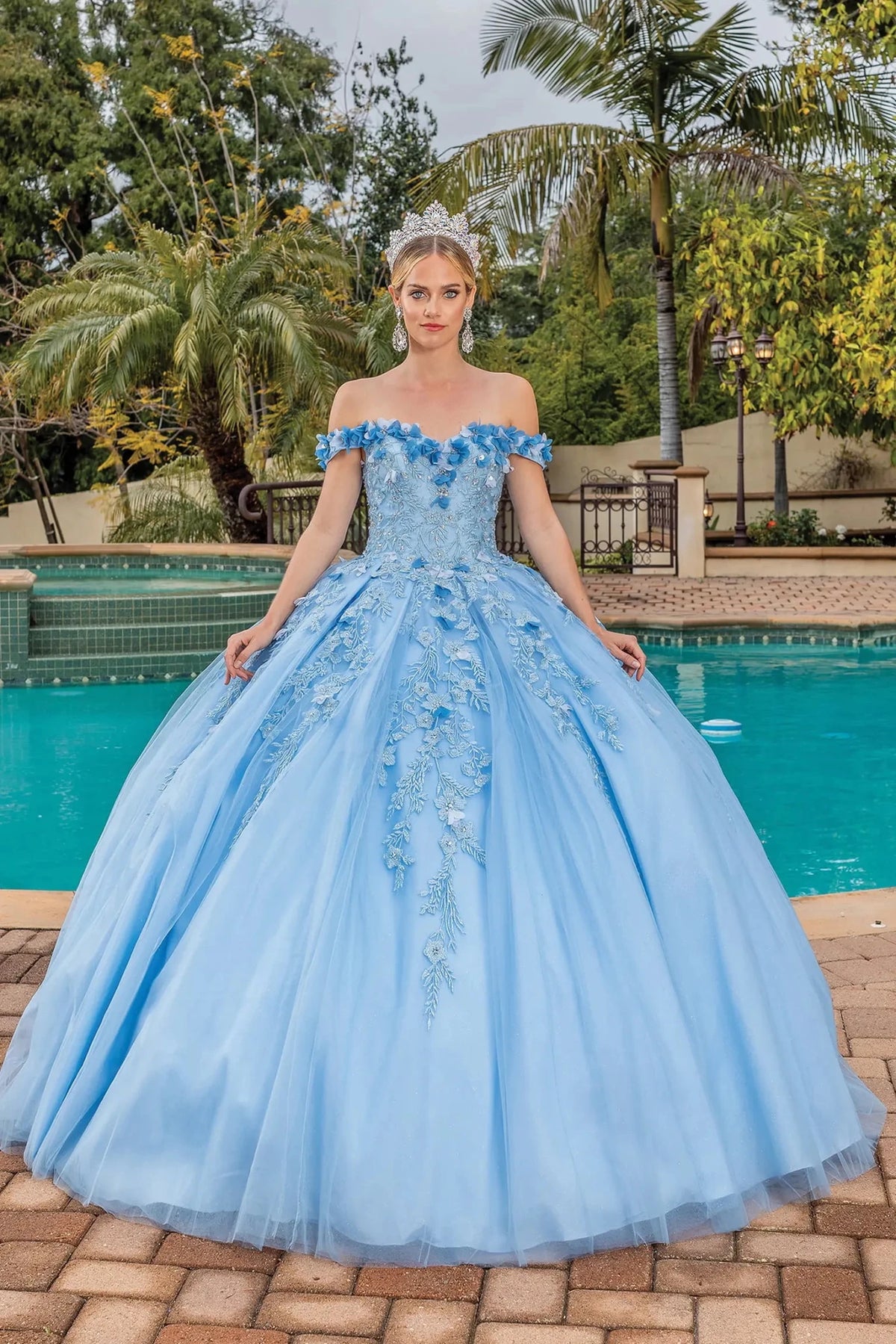 Front view of a Bahama Blue quinceañera gown with off-the-shoulder neckline and lace appliqués
