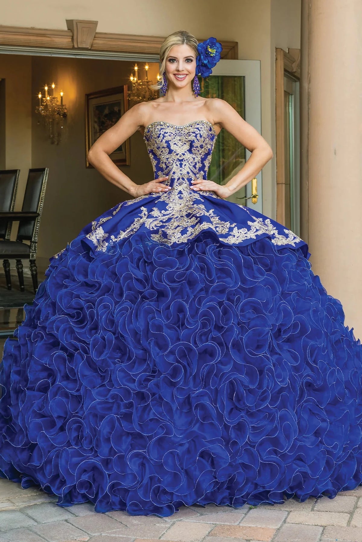 Front view of a Royal Blue quinceañera gown with beaded bodice and cascading organza ruffle skirt