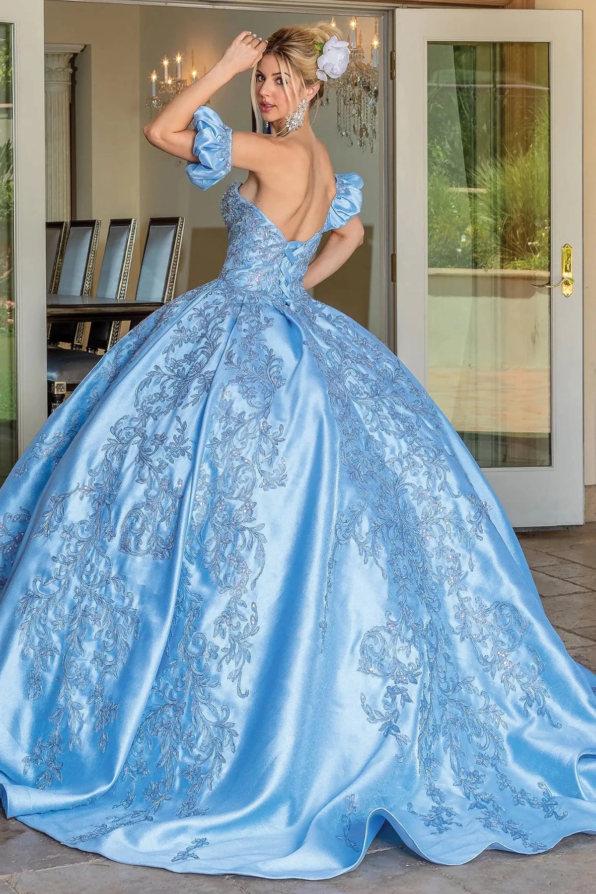 Back view of a Bahama Blue quinceañera gown showing lace-up back and embroidered lace