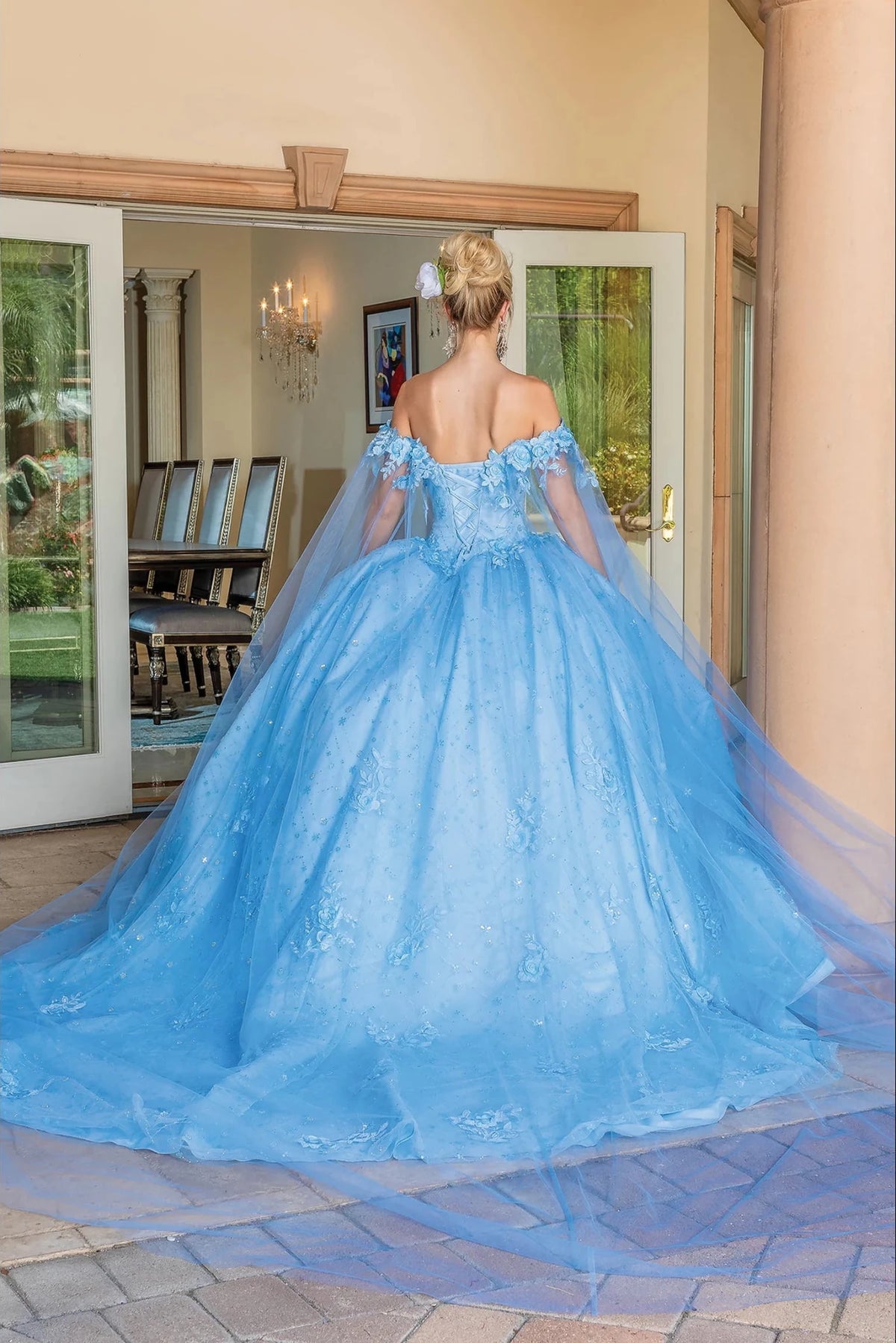 Back view of a Bahama Blue quinceañera gown showing lace-up back and floral embroidery