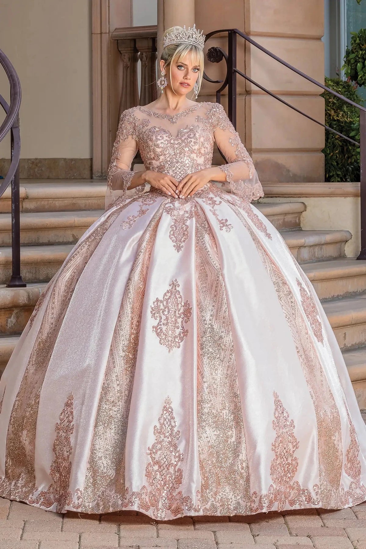 Front view of a Rose Gold quinceañera gown with off-the-shoulder neckline, embroidered lace, and glitter tulle skirt